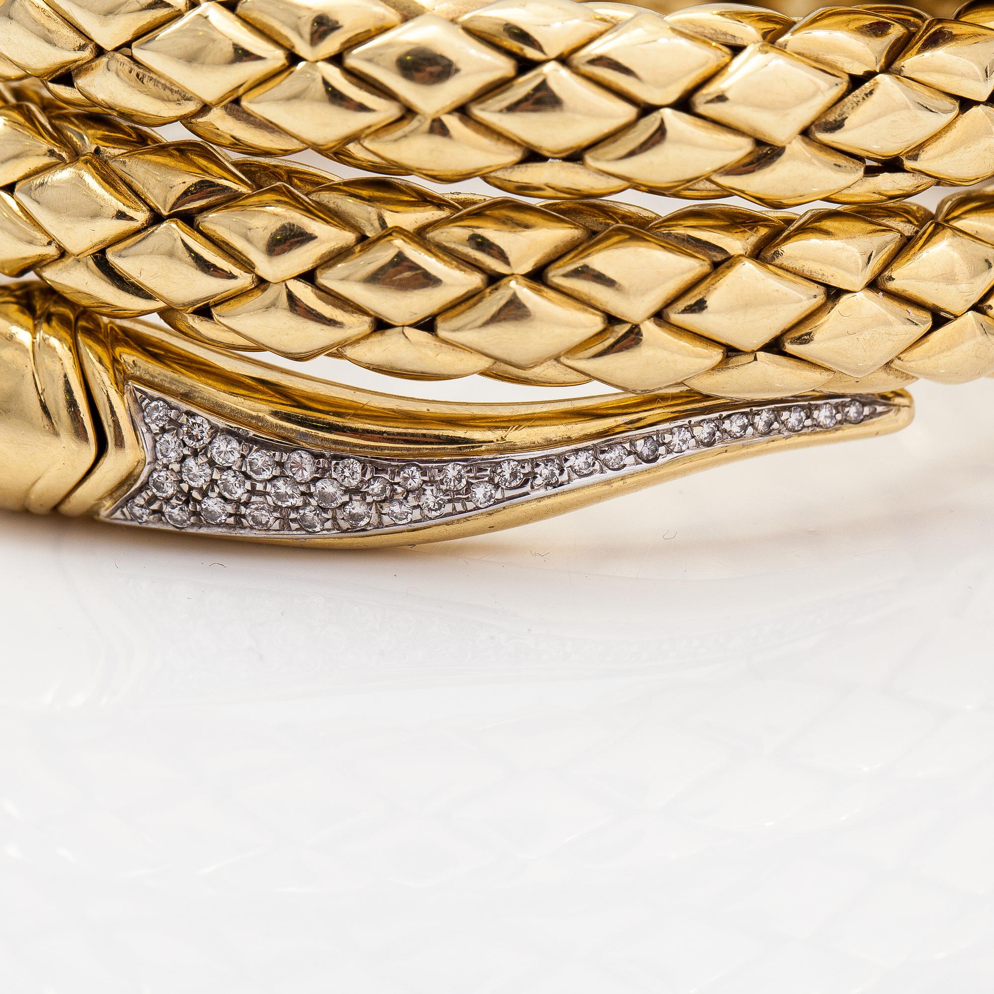 Chimento, An 18K gold snake bracelet with rubies and diamonds ca. 0.46 t in total. Italy.