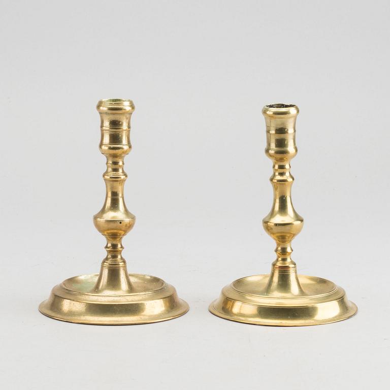 A set of two of brass candle sticks mid 18th century.