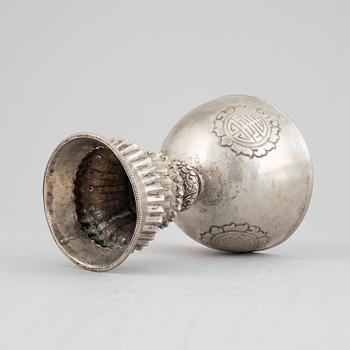 A Tibetan butter lamp, silvered copper, 20th century.