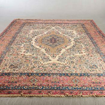 A semiantique Kirman carpet ca 415 x 302 cm.