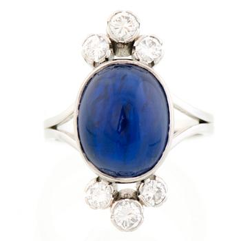 A RING, cabochon cut sapphire, brilliant cut diamonds, platinum. A. Tillander.