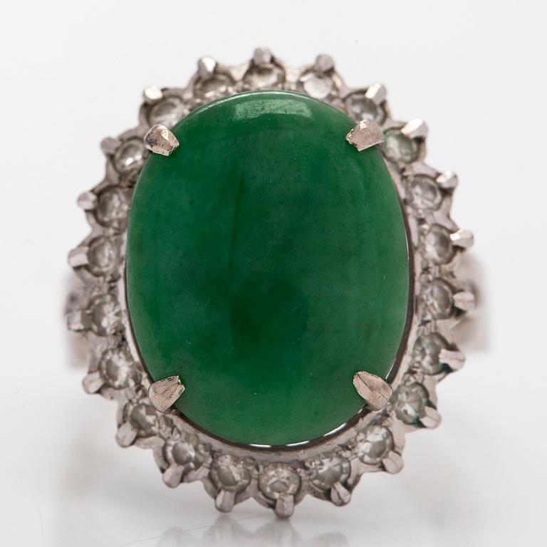 A palladium-plated silver ring with cabochon-cut jadeite and diamonds.