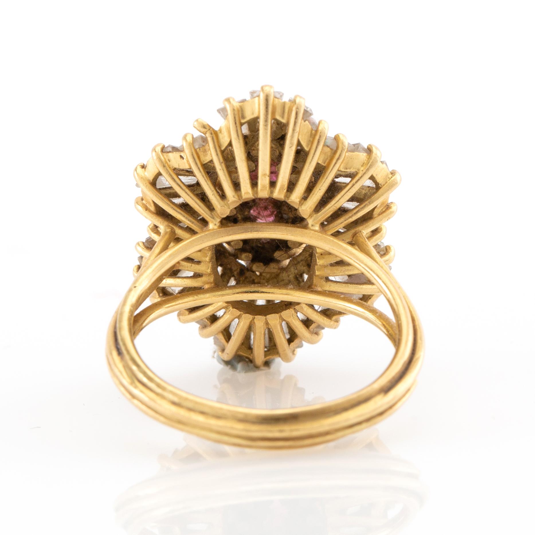 Ring in 18K gold with a marquise-cut red stone and baguette-cut diamonds.