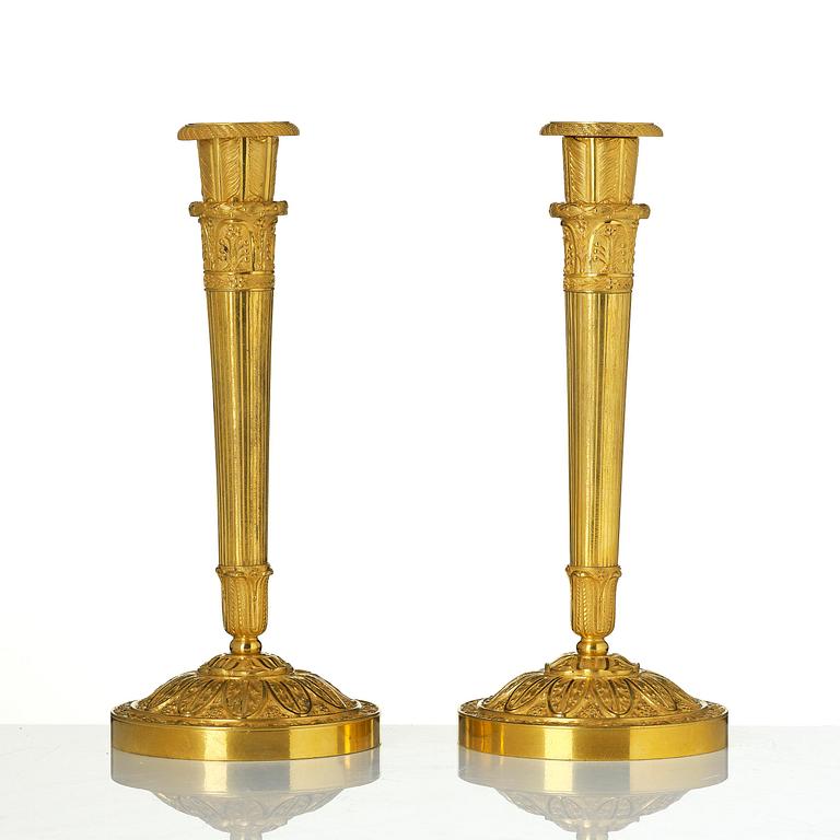 A pair of Empire ormolu candlesticks.
