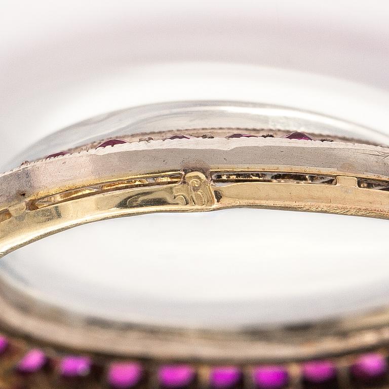 A 14K gold and silver necklace with a moon stone, rubies and a red glass stone.