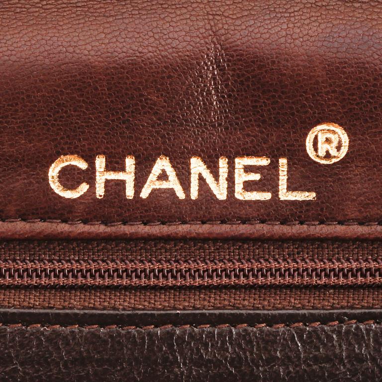 CHANEL, a brown canvs and leather crossbody bag.