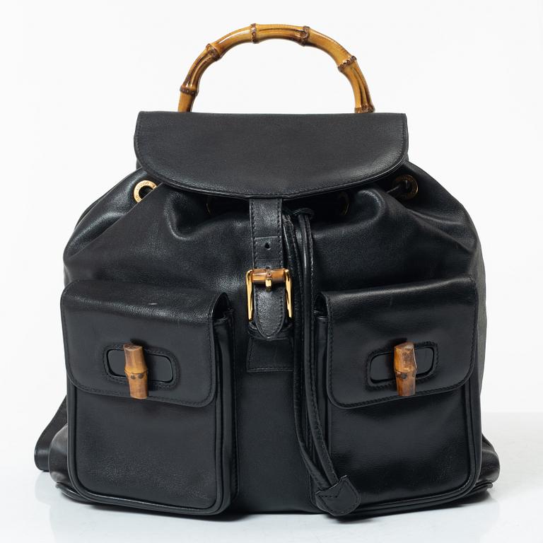 Gucci, A black leather backpack.