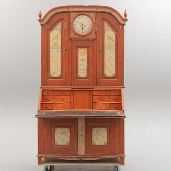 An end of the 18th century cabinet with clock.