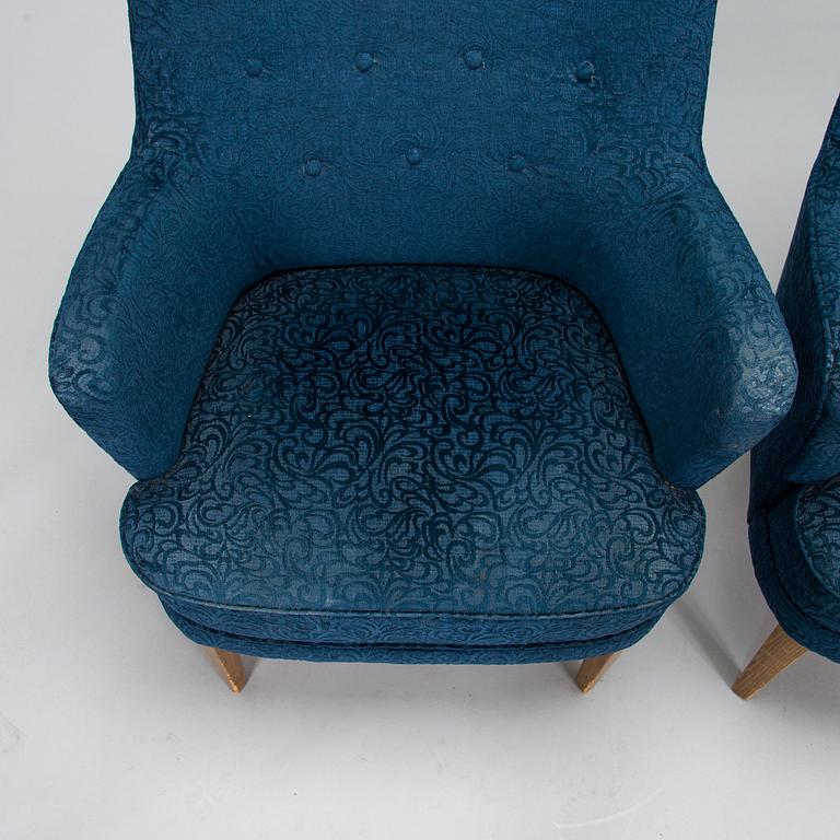 A pair of mid-20th-century armchairs.