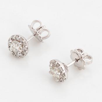 A pair of brilliant-cut diamond earrings.