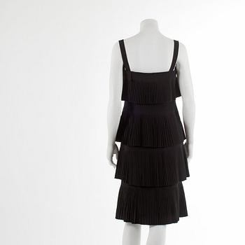 OSCAR DE LA RENTA reportedly, a pleated black cotton frill dress.