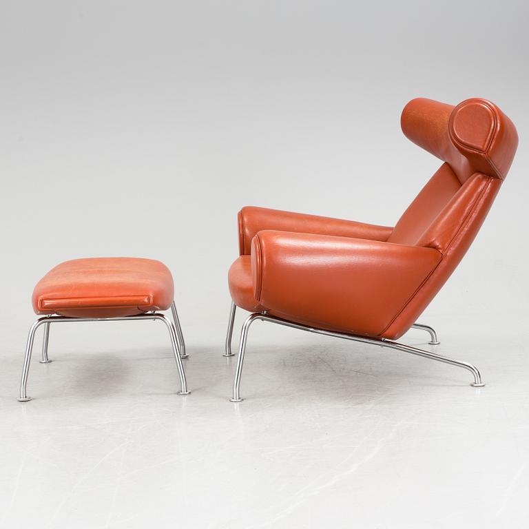 An "Ox-Chair" and foot stool by Hans J Wegner for Erik Jorgensen, Denmark.
