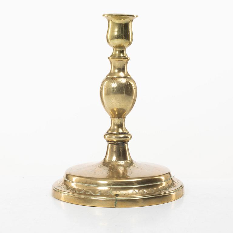 A candle holder in brass, Baroque, 17th/18th century.