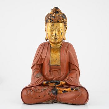 A large Vietnamese gilt and lacquered wooden buddha, circa 1900.