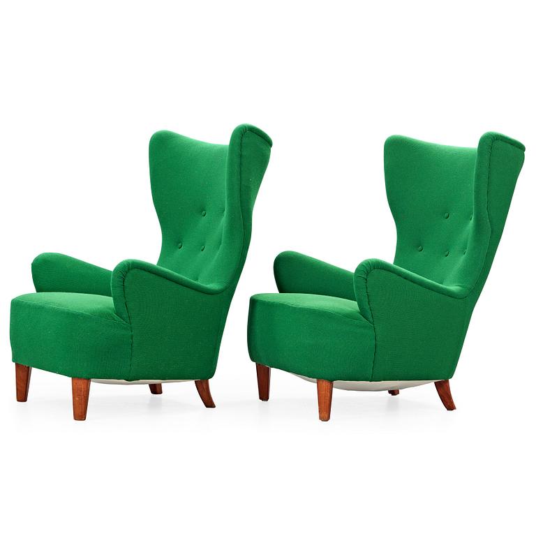 A pair of Arne Färnrot upholstered armchairs, Sweden 1940's-50's.