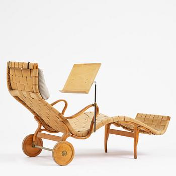 Bruno Mathsson, a lounge chair with wheels, Firma Karl Mathsson, Värnamo, 1940s, with reading table from 1972.