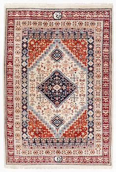 A signed oriental carpet, approx. 268 x 182 cm.