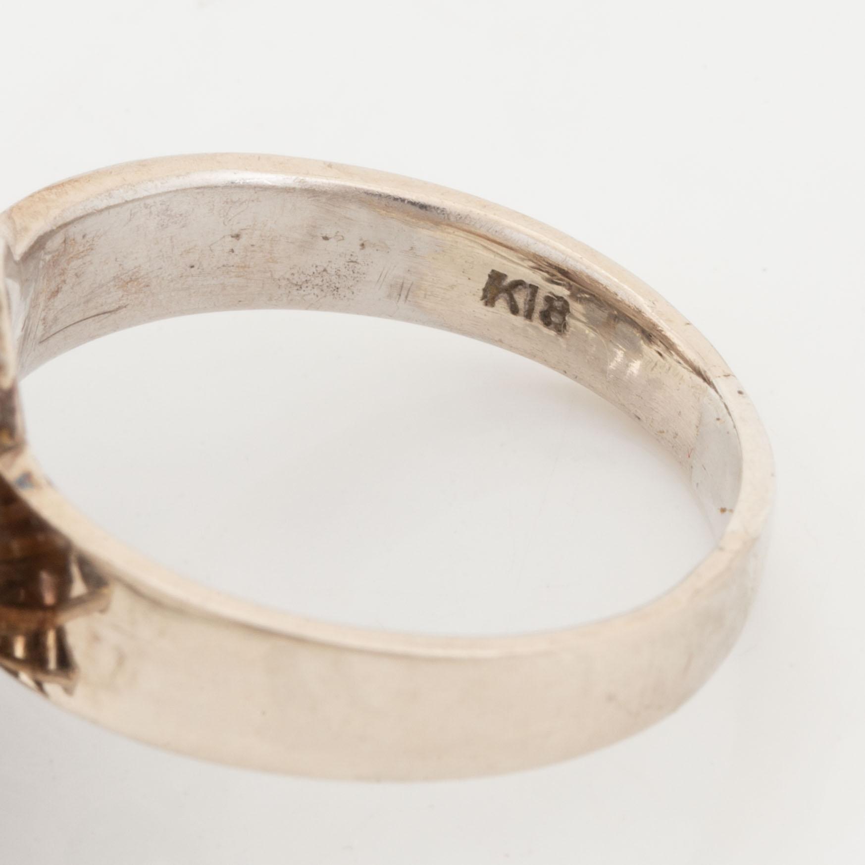 A pearl and diamond ring.