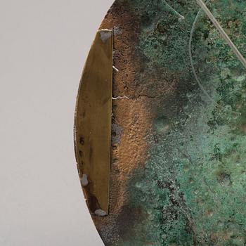 Three 20th century stone objects, with one bronze shield.