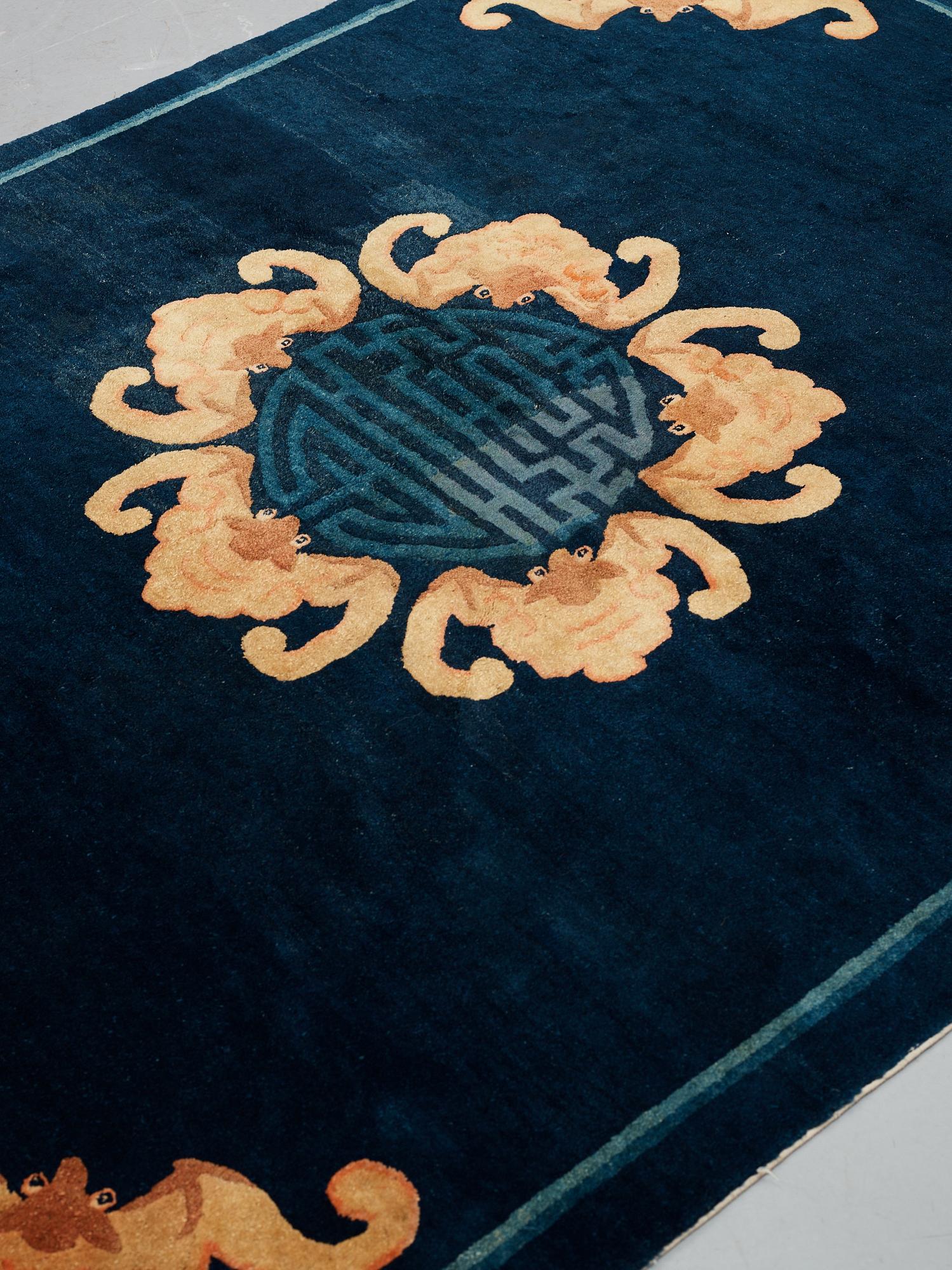 A carpet, a semi-antique Chinese,  ca 255 x 199-202,5 cm.