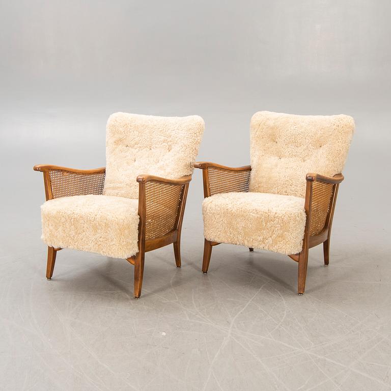 A pair of 1940/50s cheep skin armchairs.