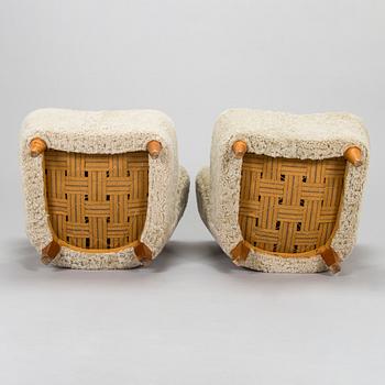 A pair of mid-20th century armchairs in sheepskin.