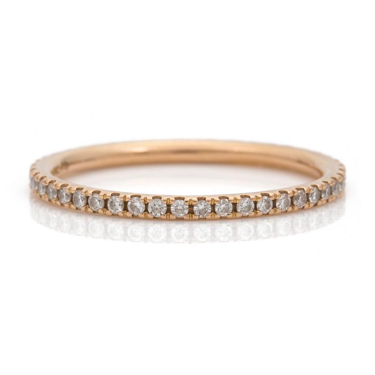 An eternity ring by Georg Jensen set with round, brilliant-cut diamonds.