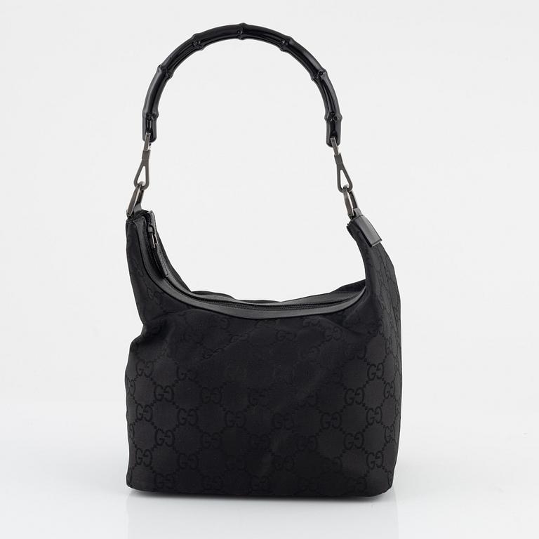 Gucci, a canvas handbag.