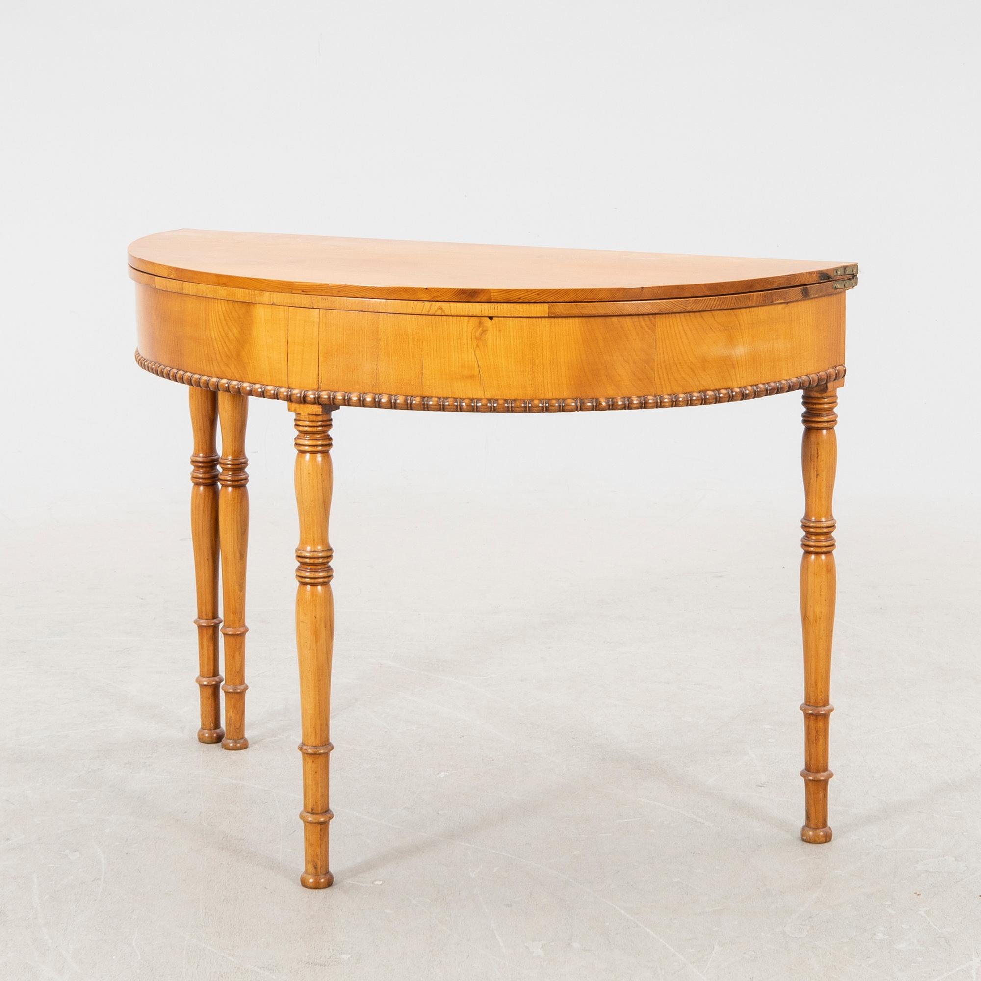 A kid 1800s late Empire birch game table.