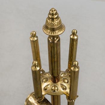 A set of 4 brass fire utensils with stand, 20th Century.