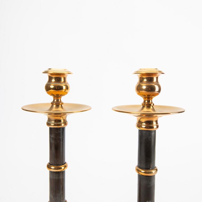 A pair of brass and wood candle sticks early 1900s.