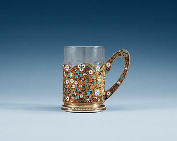 A RUSSIAN SILVER-GILT AND ENAMEL TEA-GLASS HOLDER, Makers mark of 11th Artel, Moscow 1908-1917.