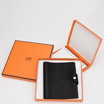 HERMÈS, a black leather notebook, "Ulysse Petit Modèle".