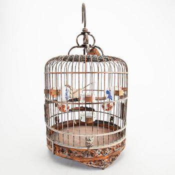 A Chinese bird cage with bird feeders, 20th Century.