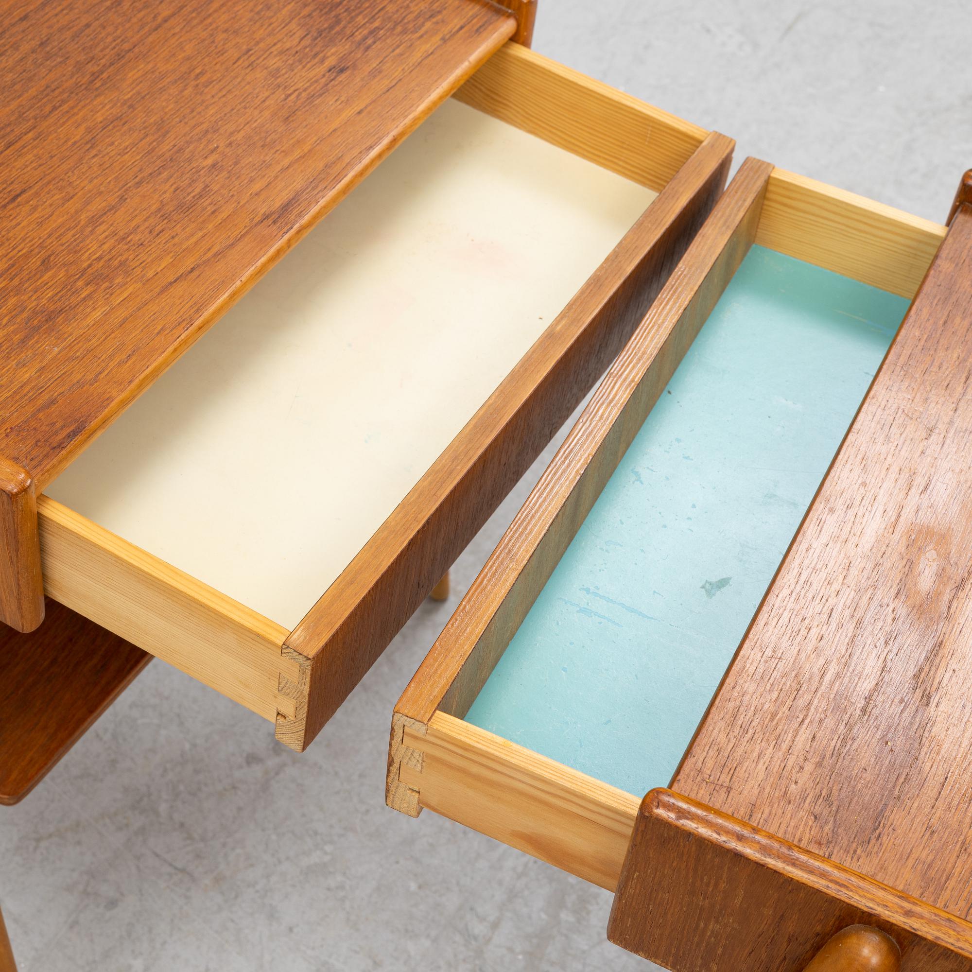 A pair of teak veneered bedside tables, 1960's.