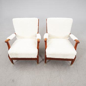 A pair of 1940s cheepskin armchairs.