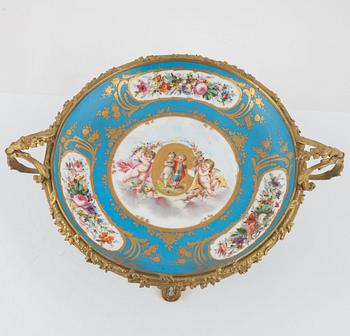 A French porcelain and brass centrepiece, second half of the 19th Century.