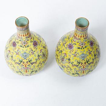 A pair of Chinese yellow ground porcelain vases, 1900s.