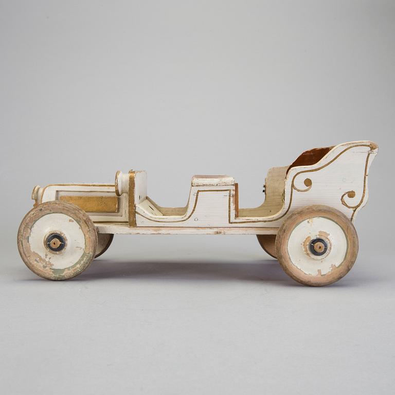 A painted wooden toy car c. 1910.
