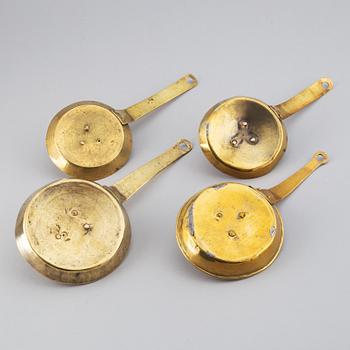 Four 18th century brass night light holders.