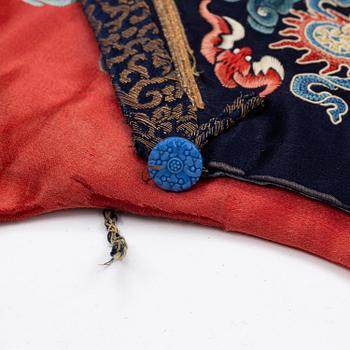 An embroidered red ground five clawed dragon 'female' formal robe, Qing dynasty, 19th century.