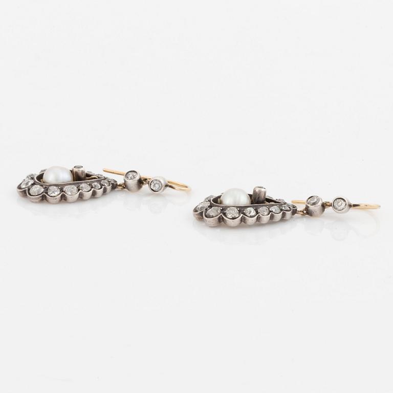 A pair of silver and gold earrings set with old-cut diamonds and pearls.