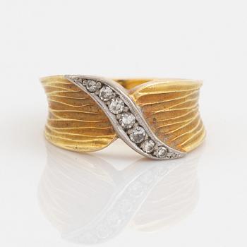 An 18K gold ring set with eight-cut diamonds.