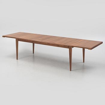 A walnut veneered extendable 'S-table' from Gubi.