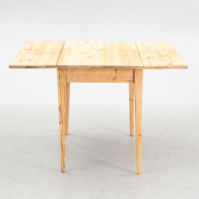 A drop-leaf table, circa 1900.