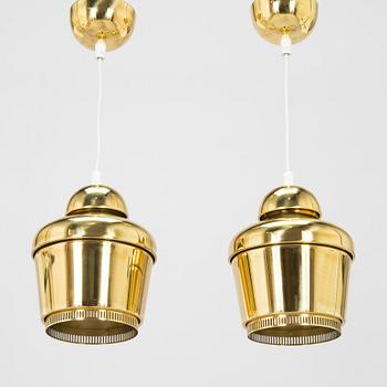 Alvar Aalto, A pair of  A 330, 'Golden Bell' pendant lights A330 for Artek, 2000s.