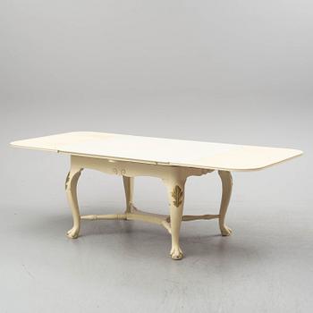 A dining table and six chairs, rococo style, mid 20th century.