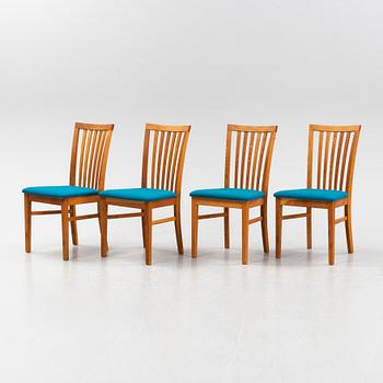 A set of four oak chairs from around the year 2000.