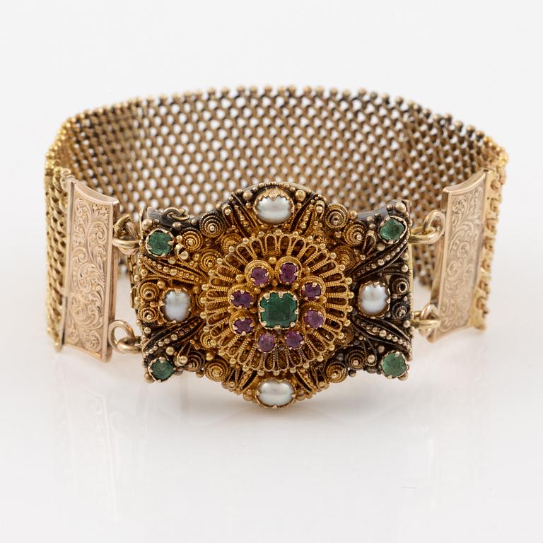 Bracelet in gold with pearls, emeralds, and rubies.