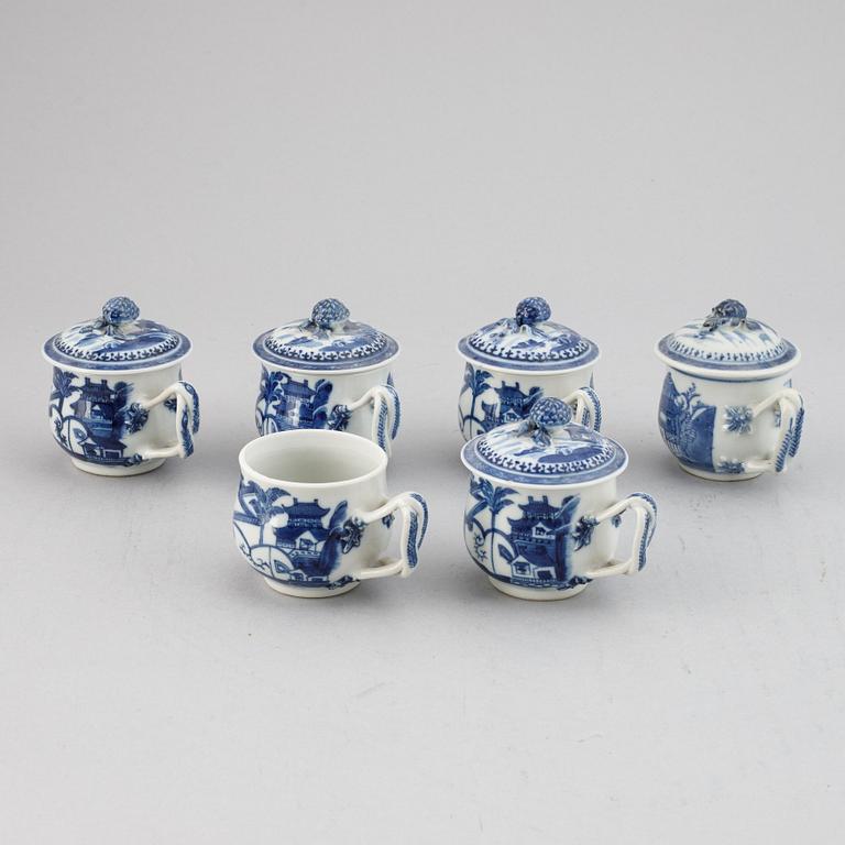 A set of six blue and white custard cups with covers,